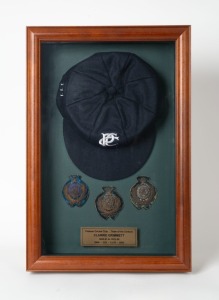 CLARRIE GRIMMETT'S posthumous presentation/display on his nomination to the PRAHRAN CRICKET CLUB'S TEAM OF THE 20th CENTURY; comprising of a commemorative cap (with Grimmett's number "111" embroidered to the side, mounted together with original 1920-21, 1921-22 and 1922-23 embroidered cap badges, together with a plaque recording Grimmett's achievements for the club: 45 matches between 1920-24, 228 wickets at 12.93 and 35 catches or stumpings. Overall 50 x 33.5cm.