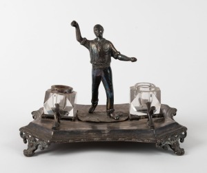 Silver plated desk set adorned with a figure of a bowler in action, both inkwells present (one without metal rim), made by James Deakin & Sons, Sheffield, circa 1900.