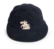 1965-66 ASHES SERIES IN AUSTRALIA: English&nbsp;Cricket Cap in deep blue with embroidered 'St George and the Dragon' on the front, worn by English fast bowler Jeff Jones during the series and exchanged with Graham McKenzie. The name "I.J.Jones" is hand-written
