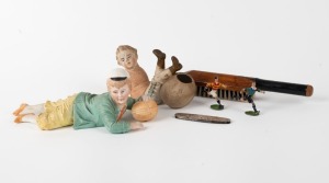 A bisque figurine of a capped boy with a football; another bisque boy footballer; two hand-painted cast lead footballer figurines; a white metal pocket knife with football scenes depicted on both surfaces of the body and a cricket-bat shaped clothes brush marked "Souvenir of Australia". (6 items). Mixed condition.