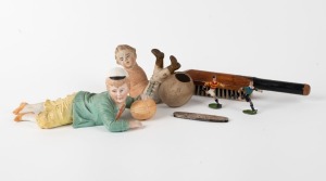 A bisque figurine of a capped boy with a football; another bisque boy footballer; two hand-painted cast lead footballer figurines; a white metal pocket knife with football scenes depicted on both surfaces of the body and a cricket-bat shaped clothes brush