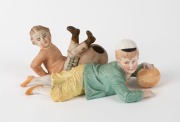 A bisque figurine of a capped boy with a football; another bisque boy footballer; two hand-painted cast lead footballer figurines; a white metal pocket knife with football scenes depicted on both surfaces of the body and a cricket-bat shaped clothes brush - 4