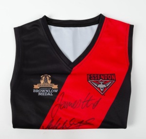 ESSENDON: Celebrating The History of the Brownlow Medal souvenir club jersey signed by winners Graham Moss, Gavin Wanganeen, James Hird and Jobe Watson.