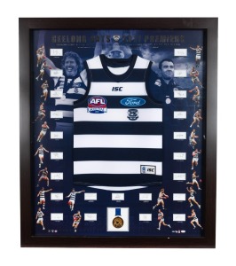 GEELONG CATS: 2011 Premiership display featuring a commemorative Grand Final jersey surrounded by photographs of all team members and their original signatures (23 total); complimented by a replica Premiership medal. Accompanied by an AFL official Certification of Authenticity and limitation, this being 17 of only 100 produced. Framed and glazed, overall 126 x 118cm.