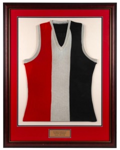 Southern Districts Football Club guernsey worn by Nathan Buckley while playing for Southern Districts in the Northern Territory Football League, 1990-91. Framed & glazed.