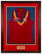 South Australian State Representative guernsey worn by Nathan Buckley while representing the SANFL in a game against the WAFL played on May 12 1992. Framed & glazed.This was not a State of Origin contest but a game played between representative sides from