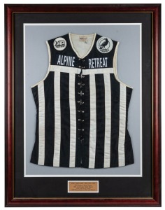Port Adelaide lace-up guernsey worn by Nathan Buckley in the 1992 SANFL Grand Final, in which Port defeated Glenelg by 56 points. Framed & glazed. Buckley won the Jack Oatey Medal for being best on ground in that game, completing a barnstorming season in which he also won the Magarey Medal and Port’s best-and-fairest. The guernsey has ‘Alpine Retreat’ branding.