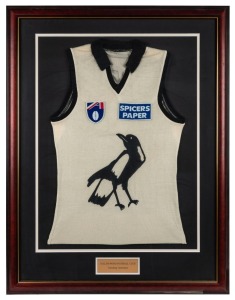 Collingwood training guernsey worn by Nathan Buckley in the 1990s. Framed & glazed. White with black magpie logo in middle with Spicers and AFL logos.