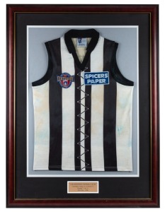 Nathan Buckley’s AFL Centenary guernsey, 1996. Collingwood guernsey worn by Buckley in the AFL’s centenary round games in 1996. Framed and glazed. Collingwood played St Kilda in this game on May 10, repeating the first match-up under the auspices of the VFL in 1897. All clubs were issued with guernseys designed to replicate the look of the lace-up guernseys worn in 1897. These guernseys were worn only in that single game.