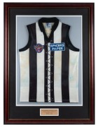 Nathan Buckley’s AFL Centenary guernsey, 1996. Collingwood guernsey worn by Buckley in the AFL’s centenary round games in 1996. Framed and glazed. Collingwood played St Kilda in this game on May 10, repeating the first match-up under the auspices of the V