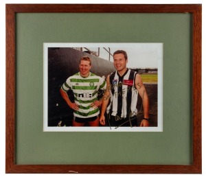 Framed photo of Nathan Buckley and soccer star Mark Viduka, with Nathan Buckley in Celtic shirt and Viduka in Collingwood jumper. Endorsed by Viduka to Nathan Buckley with message “To Nathan, C’Mon the Pies!” circa1999