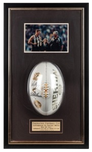 Federation Football Cup May 6th 2001. Collingwood v Carlton. A specially branded white football bearing logos of both clubs, signed by the captains, Mick Malthouse and Nathan Buckley, together with a photo of the two with the Cup after the game had been played. Very limited edition: this is #5 of 15.