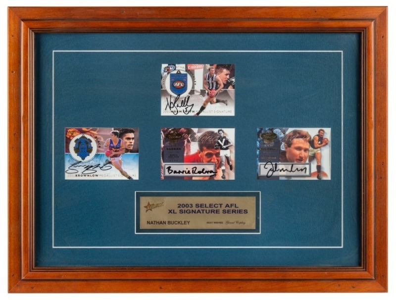 A framed display comprising four Select XL Signature Series cards 2003. The cards of Nathan Buckley, Barrie Robran, John Nicholls and Simon Black, are all hand-signed.