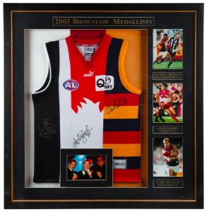 Brownlow Medal 2003. Composite guernsey created from Collingwood, Adelaide and Sydney guernseys, to commemorate the 2003 Brownlow Medal that was tied between Nathan Buckley, Mark Ricciuto and Adam Goodes. Signed by each winner, with a small photo of each.