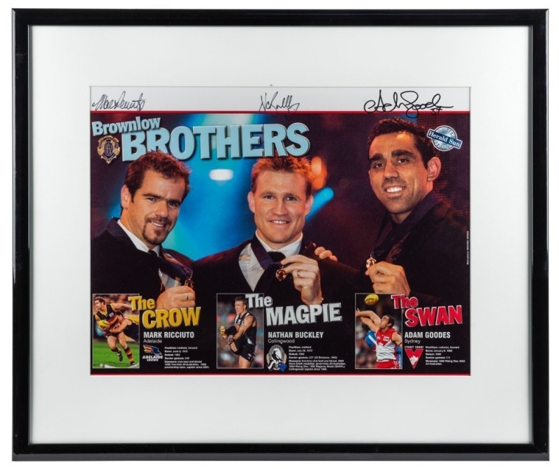 “Brownlow brothers”. Framed & glazed Herald Sun poster showing Nathan Buckley, Adam Goodes and Mark Ricciuto with their 2003 Brownlow Medals, and small stories about each. Signed by all three players.