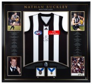 &ldquo;Nathan Buckley Masterclass&rdquo;, display comprising of a signed Collingwood jumper, window mounted with four photographs and replica Norm Smith & Brownlow Medals. Limited edition 5/200, framed & glazed, overall 188 x 117cm.