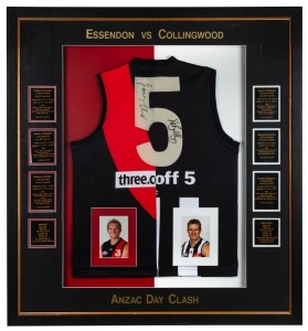 ANZAC Day Football Match Memorabilia: A display with number "5" jumper, half Collingwood & half Essendon, signed on the number by Nathan Buckley and James Hird. With results of the ANZAC Day clashes between1998-2003. Window mounted, framed & glazed, overall 100x108cm.