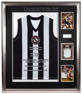 Collingwood Football Club Hall of Fame: Nathan Buckley’s Hall of Fame guernsey presented to him by the Collingwood Football Club at the inaugural Hall of Fame induction dinner in 2004. The display features a special Hall of Fame guernsey, together with ph