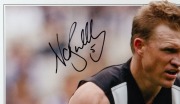 &ldquo;Nathan Buckley &ndash; Collingwood Champion&rdquo;. Produced in Buckley&rsquo;s final season, 2007, this signed piece of Elite Sports memorabilia also includes a swatch of a guernsey worn by Buckley during the 2007 season. Number 5 of 280. Signed and framed. - 2