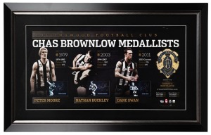Framed lithograph signed by Collingwood’s three living Brownlow Medallists, circa 2012 – Dane Swan, Peter Moore and Nathan Buckley. The display comprises of a single image of each player, plus a replica Brownlow Medal. Signed by all three players. Limited edition of 200, this is an Artist’s Proof edition given to Buckley. 53 X 85cm overall.