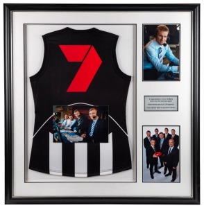 CHANNEL SEVEN: A display comprising of a Collingwood guernsey with Channel 7 logo on rear, together with several photos of Nathan Buckley in the commentary box or with other members of Channel 7’s commentary team. Framed & glazed.Presented to Buckley by h