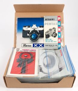 ASAHI KOGAKU: One A4 archive box containing seventy Asahi Kogaku product brochures, sales guides, and instruction booklets, each sealed in a plastic sleeve. (70 items)