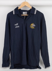 International Rules series v Ireland 1999. Official team polo worn by Nathan Buckley during the series of hybrid matches played against Ireland in Australia in 1999. Navy blue with white piping and Australian crest. Long-sleeved.