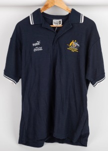 International Rules series v Ireland 1999. Official team polo worn by Nathan Buckley during the series of hybrid matches played against Ireland in Australia in 1999. Navy blue with white piping and Australian crest. Short-sleeved.