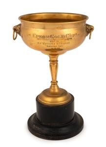 "THE EPSOM GOLD CUP Won by H.P WATSON & R.C. Bakers 'RADIANT BOY' 31.8.35," made by T. Gaunt & Co. in gold-plated brass and mounted on a wooden plinth. Overall 27cm tall