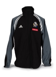Nathan Buckley’s Collingwood players’ jacket circa 2001-02. Black adidas jacket with full zip, adidas logo on right breast, Collingwood logo on left breast, above small red Emirates patch. Black front with grey sleeves and white striping/highlights. Large red Emirates patch and adidas logo on rear.