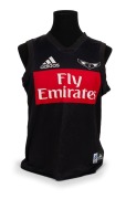 Nathan Buckley’s training singlet. Black with large red ‘Fly Emirates’ patch in middle of chest, adidas and swooping magpie logos above. Number 5 and ‘Wipe Off 5 TAC’ in white on reverse. Worn 2002-04.