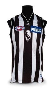 Nathan Buckley’s Collingwood guernsey 2000. Away guernsey made by adidas ("X LARGE") match worn by Buckley during the 2000 season, with Magpie in oval on front, blue Primus logo on front and ‘shield’ style number / Emirates patch on rear. Also with adidas
