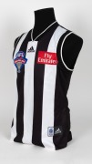 Nathan Buckley’s 2003 Grand Final guernsey. The Magpies went into the Grand Final with high hopes that they could atone for the previous year’s loss, but it was a dirty day for the black-and-white army as the team lost by 50 points. This is the jumper Buc - 2