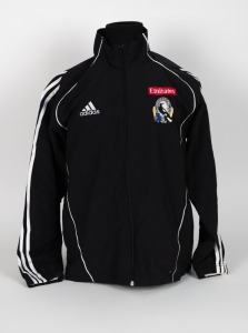 Nathan Buckley’s Collingwood players’ jacket, circa 2006. Black adidas full-zip jacket with adidas logo top right, Emirates top left and Collingwood logo beneath that. Fly Emirates single line logo on reverse.