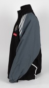 Nathan Buckley’s Collingwood players’ jacket circa 2001-02. Black adidas jacket with full zip, adidas logo on right breast, Collingwood logo on left breast, above small red Emirates patch. Black front with grey sleeves and white striping/highlights. Large - 3