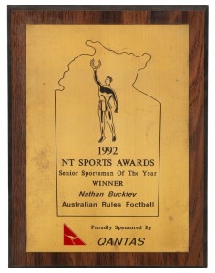 Northern Territory Sports Awards, 1992. Wooden plaque with metal plate, awarded to Nathan Buckley as ‘Senior Sportsman of the Year’. Together with a similar framed plaque with engraved "Certificate for Outstanding Achievements Awarded to Nathan Buckley Australian Rules Football, in the category fo Senior Sportsman of the Year". (2 items).