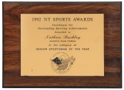 Northern Territory Sports Awards, 1992. Wooden plaque with metal plate, awarded to Nathan Buckley as ‘Senior Sportsman of the Year’. Together with a similar framed plaque with engraved "Certificate for Outstanding Achievements Awarded to Nathan Buckley Au - 2