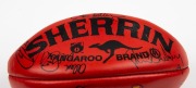 100th GAME FOOTBALL: A red Sherrin football with yellow McDonald’s logo, signed by Nathan Buckley and other players including Josh Mahoney, Brad Cassidy, Andrew Schauble, Jason Wild, Scott Russell, Simon Prestigiacomo, Paul Williams and others. Note: the - 2