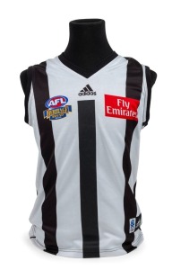 Nathan Buckley’s 2003 Heritage Round guernsey. This was the AFL’s first official Heritage Round, played in Round 19, 2003. Collingwood played Brisbane, and wore a guernsey based on the one it wore during the late 1920s through to the early 1950s. Together with a framed photo of Buckley and Michael Voss tossing the coin before the game, signed by both captains. (2 items).