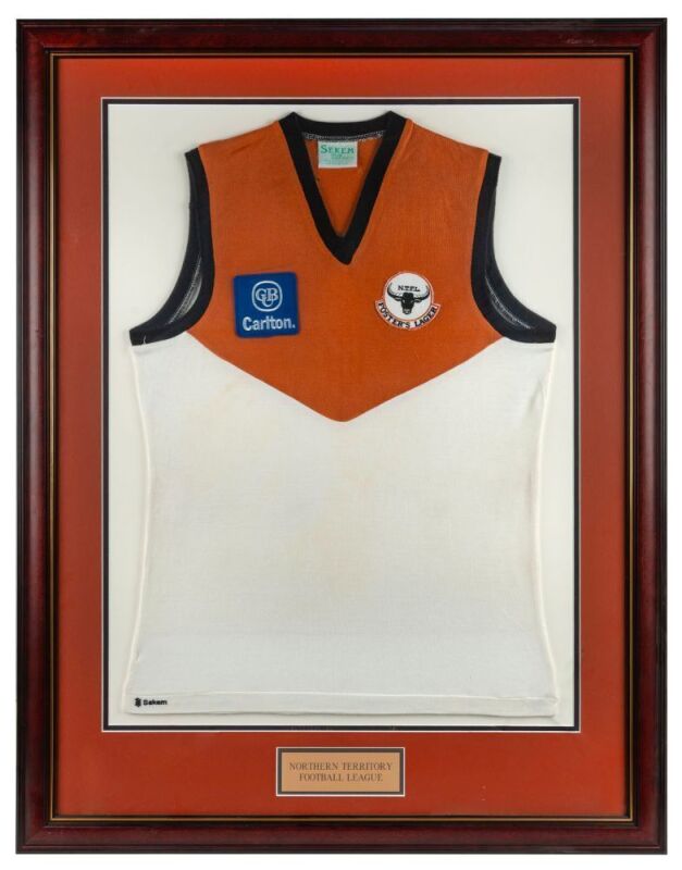 NTFL representative side 1992. Guernsey worn by Nathan Buckley while playing for the NTFL representative team in the game against Geelong, 26 January 1992. Framed & glazed.