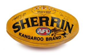 250th game football: A yellow/tan Sherrin with Hard Yakka branding, used in Nathan Buckley’s 250th Collingwood game v Hawthorn at the MCG in 2006. Signed by the three officiating umpires (Stephen McBurney, Stefan Grun and Scott Jeffrey).