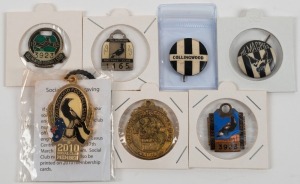 COLLINGWOOD: A range of fobs and badges including 1962,1965, 1979 and 2010 membership fobs, two supporter badges circa 1960 and a 1990 Collingwood Premiership gilt medallion. (7 items).