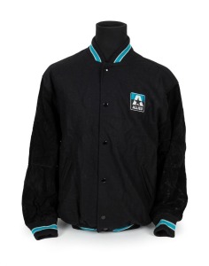 Nathan Buckley’s Allies team jacket from 1995. Thick bomber jacket with press studs, Allies badging on breast and piping in Allies colours of teal, black and white on cuffs and edges.