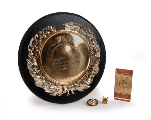 MAUREEN CAIRD'S "AUSTRALIAN OLYMPIAN" official lapel badge (made by Stokes) engraved verso "Miss M. Caird"; also, her 1968 Olympic Rings button-hole badge; and her official "MEXICO Atleta" badge (lacking the plastic flag). Accompanied by a presentation plaque "PRESENTED BY WORLD SPORTS - THE INTERNATIONAL SPORTS MAGAZINE to MAUREEN CAIRD 80 metres Hurdles in 10.3 sec. OLYMPIC GAMES CHAMPION MEXICO CITY OCTOBER 1968." (4 items).