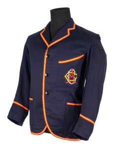ADELAIDE CRICKET CLUB BLAZER, Grimmett's Adelaide Cricket Club blazer, blue wool with yellow and red trim, with monogram initials of the A.C.C. embroidered in red, yellow, and turquoise thread; label of McCarron & Co., inscribed in ink "MR. C.V. GRIMMETT 23 - 8 -24". Provenance: The Clarrie Grimmett Collection; his family, by descent.