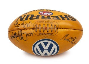 BUCKLEY'S 200th GAME: The football, a yellow/tan Sherrin with VW branding, signed by the three umpires #29 (Scott Jeffrey), 23 (Martin Ellis) and #5 (Matt James) who officiated during Buckley’s 200th career game v Carlton in 2002.
