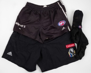 Nathan Buckley’s Collingwood playing shorts, early 2000s. Wipe off 5/TAC on right, AFL logo and adidas on left; two white stripes with AFL along edge. Worn circa 2002-2005. Together with a pair of training shorts with adidas, Emirates and CFC branding and