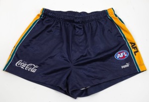 International Rules series v Ireland 1999. Nathan Buckley’s playing shorts from the games against Ireland in Australia in 1999. Dark blue with green and gold piping along the sides, with different Coca-Cola branding and AFL logo.