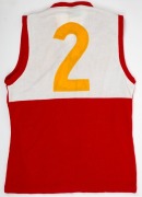 Northern Territory News ‘Team of the Year’ guernsey, 1991. Red sleeveless guernsey with yellow #2 on white patch on reverse. Presented to Nathan Buckley for being chosen in the newspaper’s Team of the Year. ‘Northern Territory News’ and ‘Winfield Team of - 2