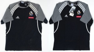 Collingwood T-shirt/training top, early 2000s. Black shirt with adidas logo on right breast and Collingwood logo on left breast, above small red Emirates patch. White stripes and grey sections on sleeves/shoulders. First issued 2001. (2 examples; one worn